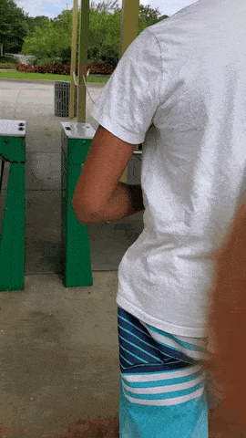 Video of a person walking past an unmanned security gate. The gate has a horizontal bar, but also leaves enough room between the divider and the bar so that a person can easily walk through.